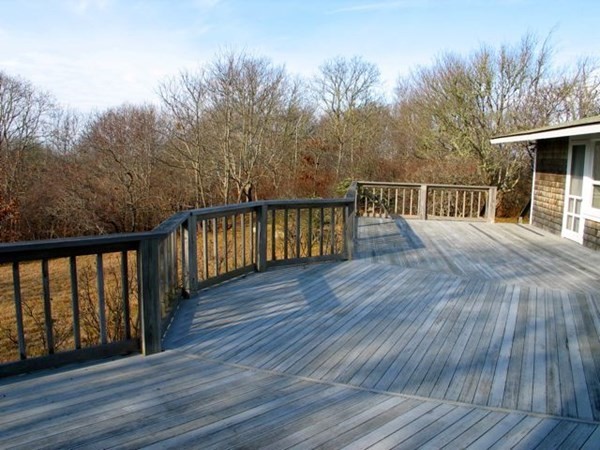 44 Flanders Lane Chilmark, MA 02535 - Photo 17 of 19 a balcony with wooden floor and yard in the back