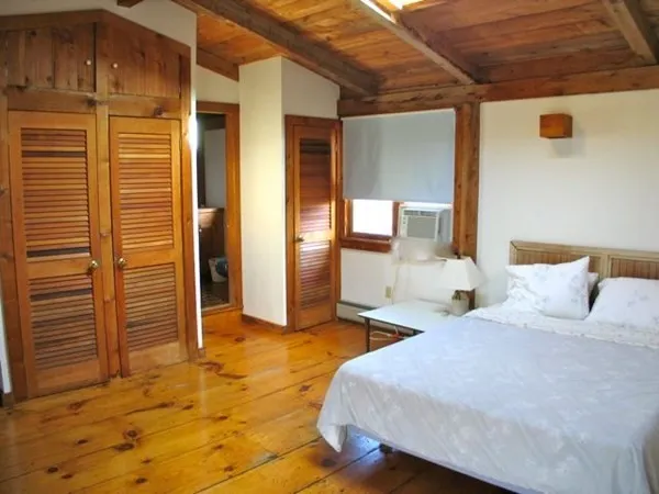 a bedroom with a bed and a cabinets