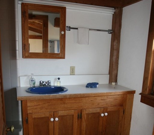 44 Flanders Lane Chilmark, MA 02535 - Photo 9 of 19 a bathroom with a sink and a mirror