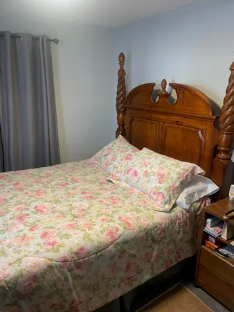 a bedroom with a bed and a shower