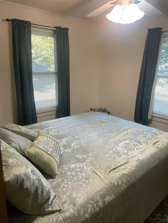 a bedroom with a bed and a window