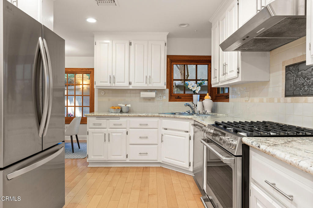 23 Hidden Valley Road Monrovia, CA 91016 - Photo 11 of 27 a kitchen with stainless steel appliances granite countertop a stove a sink and a refrigerator