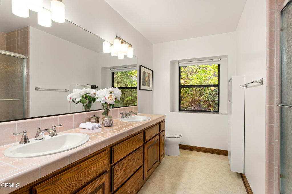 23 Hidden Valley Road Monrovia, CA 91016 - Photo 24 of 27 a bathroom with a sink double vanity granite and a mirror