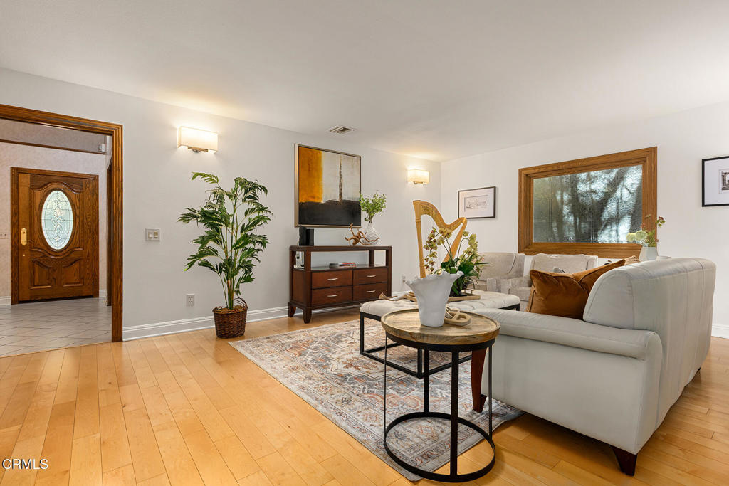 23 Hidden Valley Road Monrovia, CA 91016 - Photo 3 of 27 a living room with furniture potted plant and a wooden floor