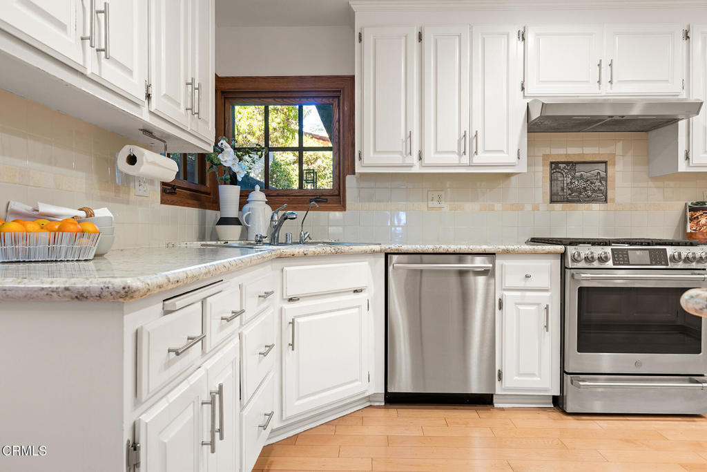 23 Hidden Valley Road Monrovia, CA 91016 - Photo 10 of 27 a kitchen with granite countertop white cabinets and white appliances