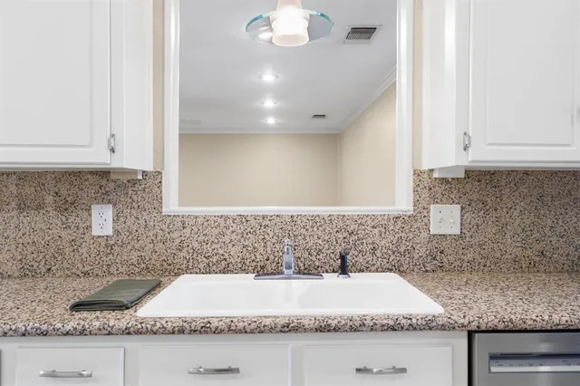 a bathroom with a granite countertop bathtub and sink