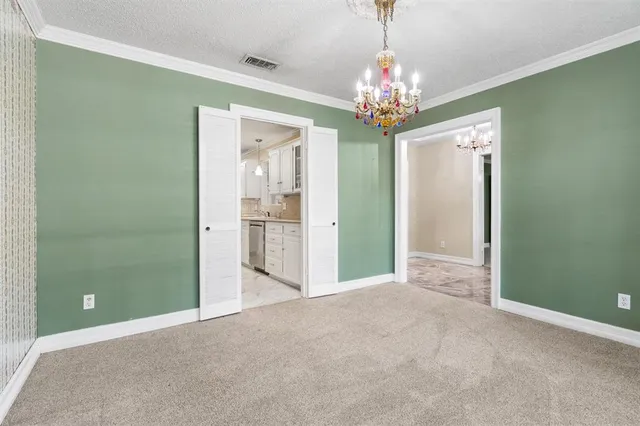 a view of a chandelier in big room and a mirror