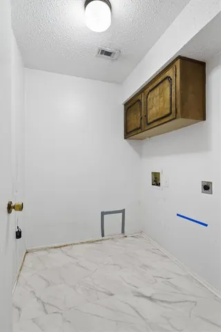 a view of a storage & utility room with a microwave