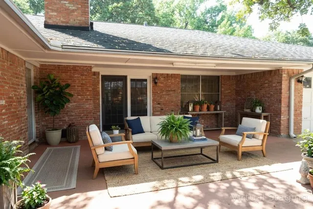 a view of a patio with couches table and chairs and potted plants