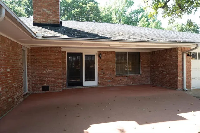 a view of a brick house with large windows
