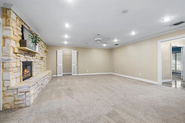 an empty room with fireplace and windows