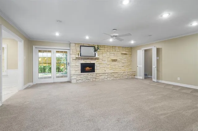 a view of empty room with a fireplace and window