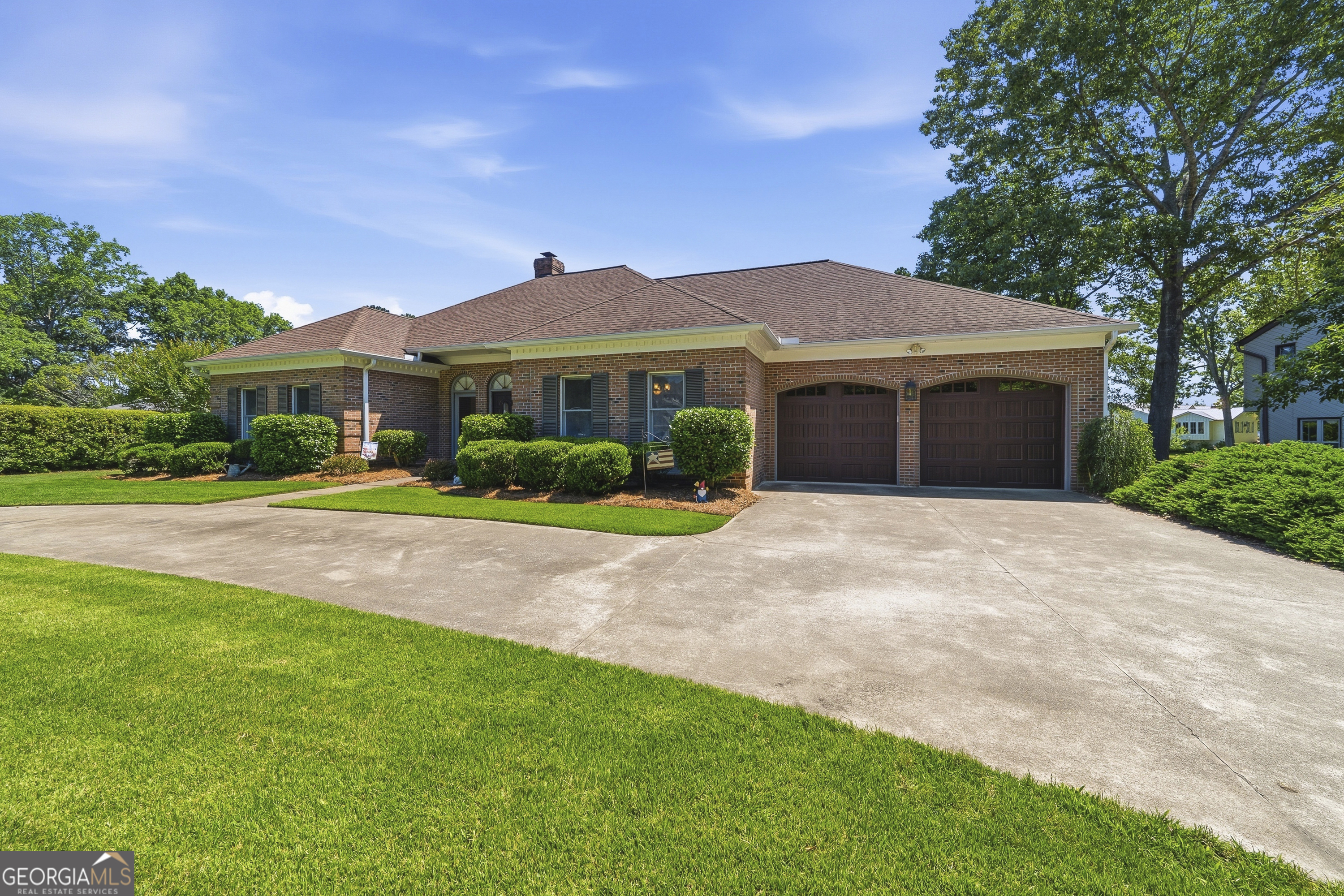 104 Spruce Point Southeast Eatonton, GA 31024 - Photo 1 of 63 a front view of a house with a yard and potted plants