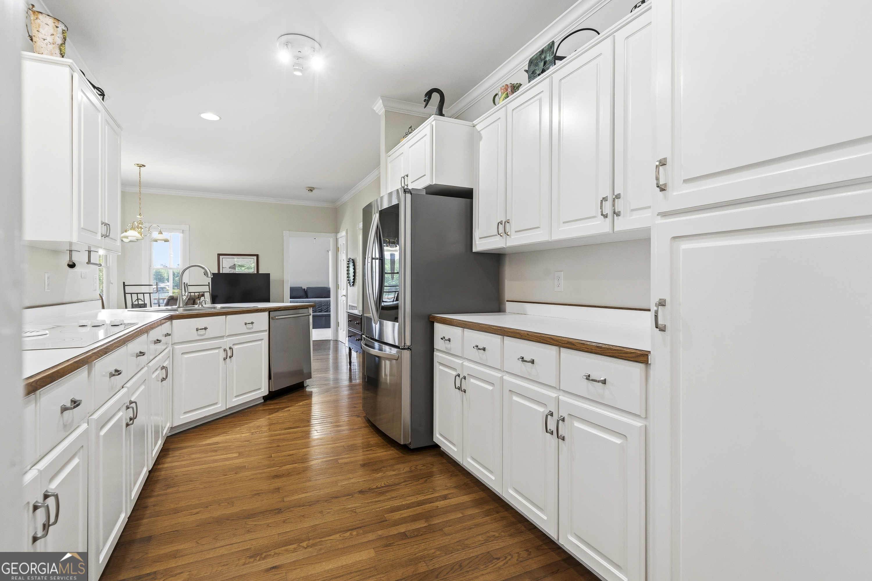 104 Spruce Point Southeast Eatonton, GA 31024 - Photo 14 of 63 a kitchen with granite countertop white cabinets and white appliances
