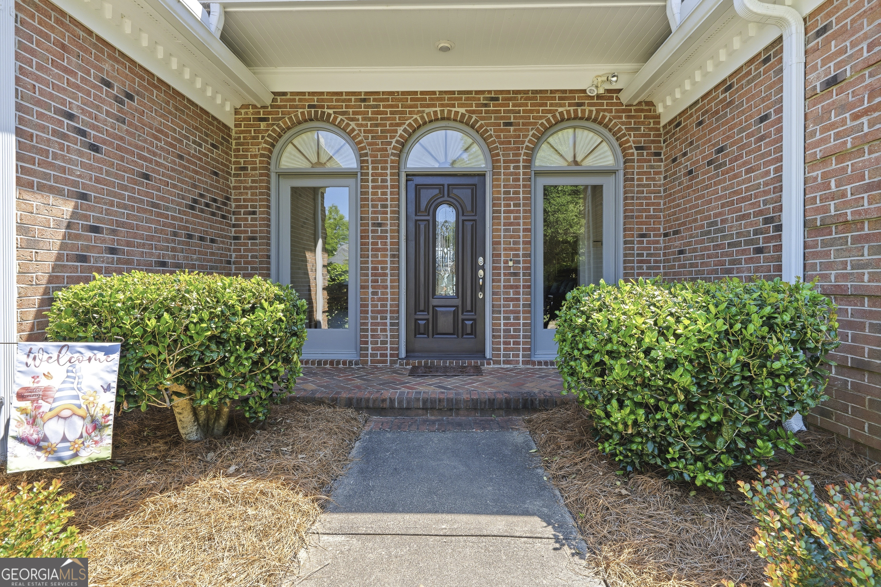 104 Spruce Point Southeast Eatonton, GA 31024 - Photo 2 of 63 a view of a house with large windows and a potted plant