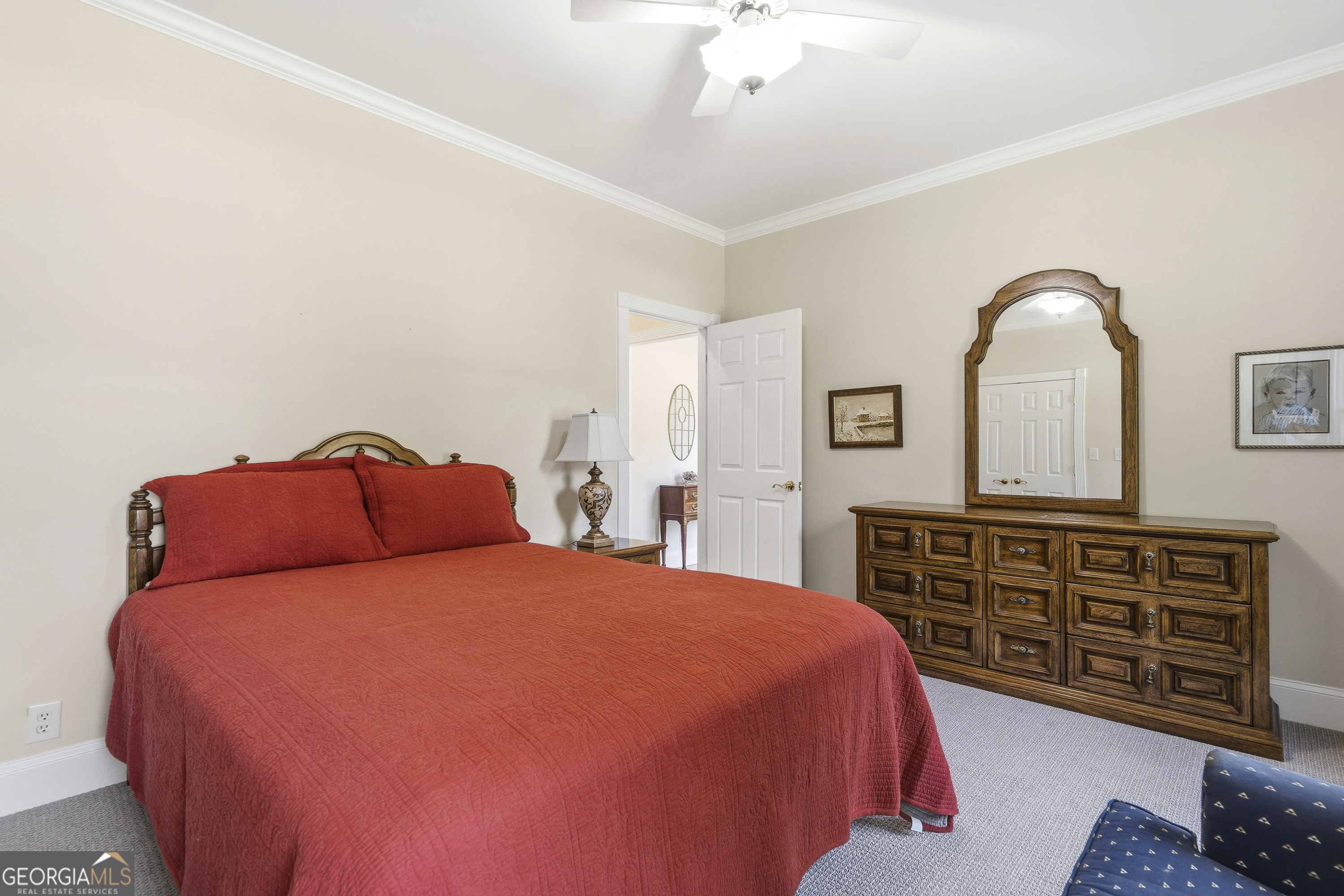 104 Spruce Point Southeast Eatonton, GA 31024 - Photo 30 of 63 a bedroom with a bed and dresser with mirror