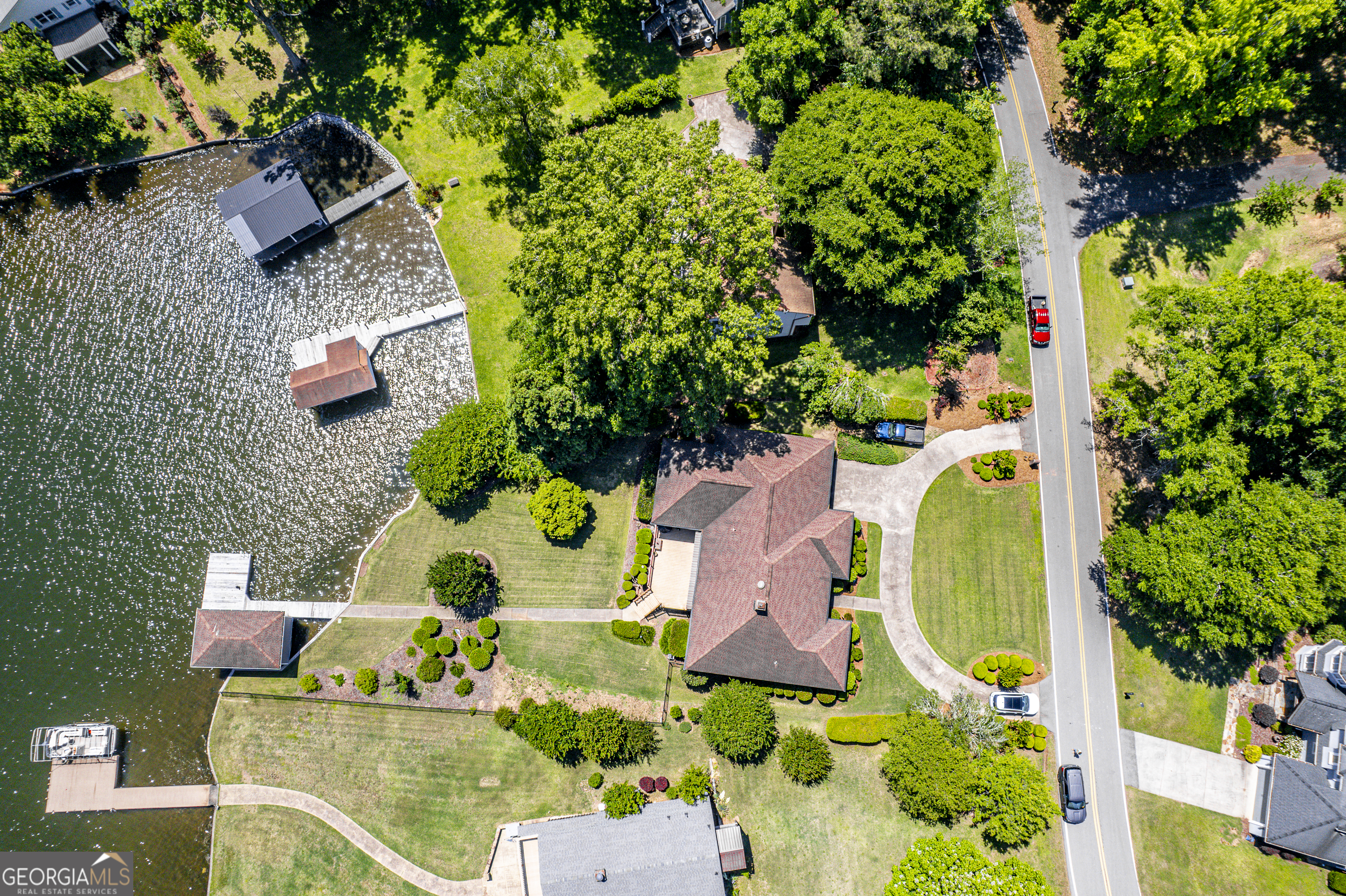 104 Spruce Point Southeast Eatonton, GA 31024 - Photo 53 of 63 an aerial view of a house a swimming pool outdoor seating and yard