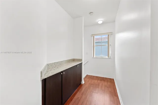 a view of hallway with wooden floor