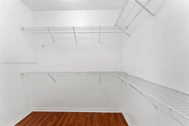 a bathroom with a granite countertop sink a mirror and a shower