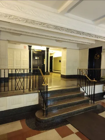 a living room with a fireplace and wooden floor