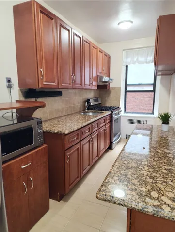 a view of a room with wooden floor and cabinet