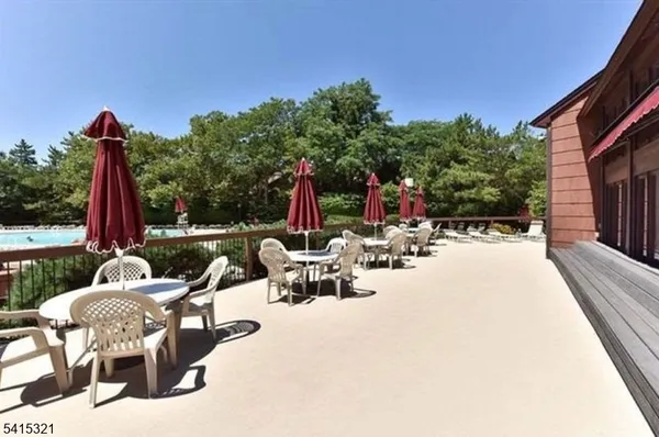 a view of swimming pool with chairs