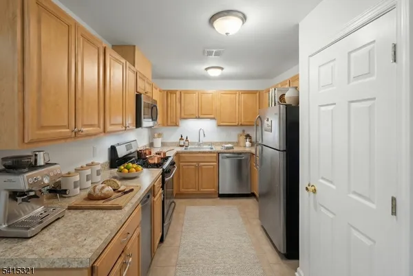 a kitchen with a sink stove and refrigerator
