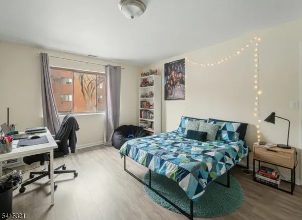 a bedroom with a bed a desk and chair
