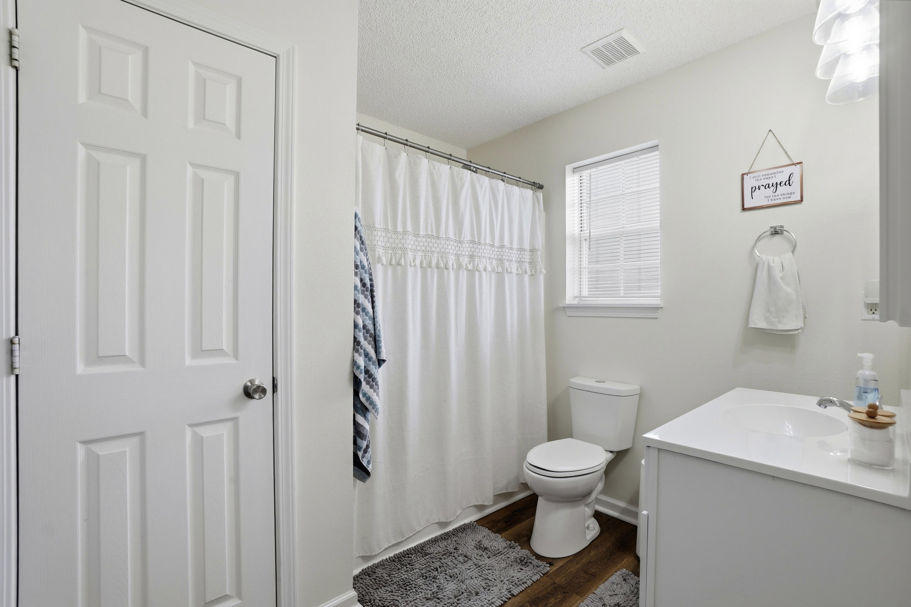 91 Oakridge Way DeFuniak Springs, FL 32433 - Photo 13 of 25 a bathroom with a toilet a sink and a window