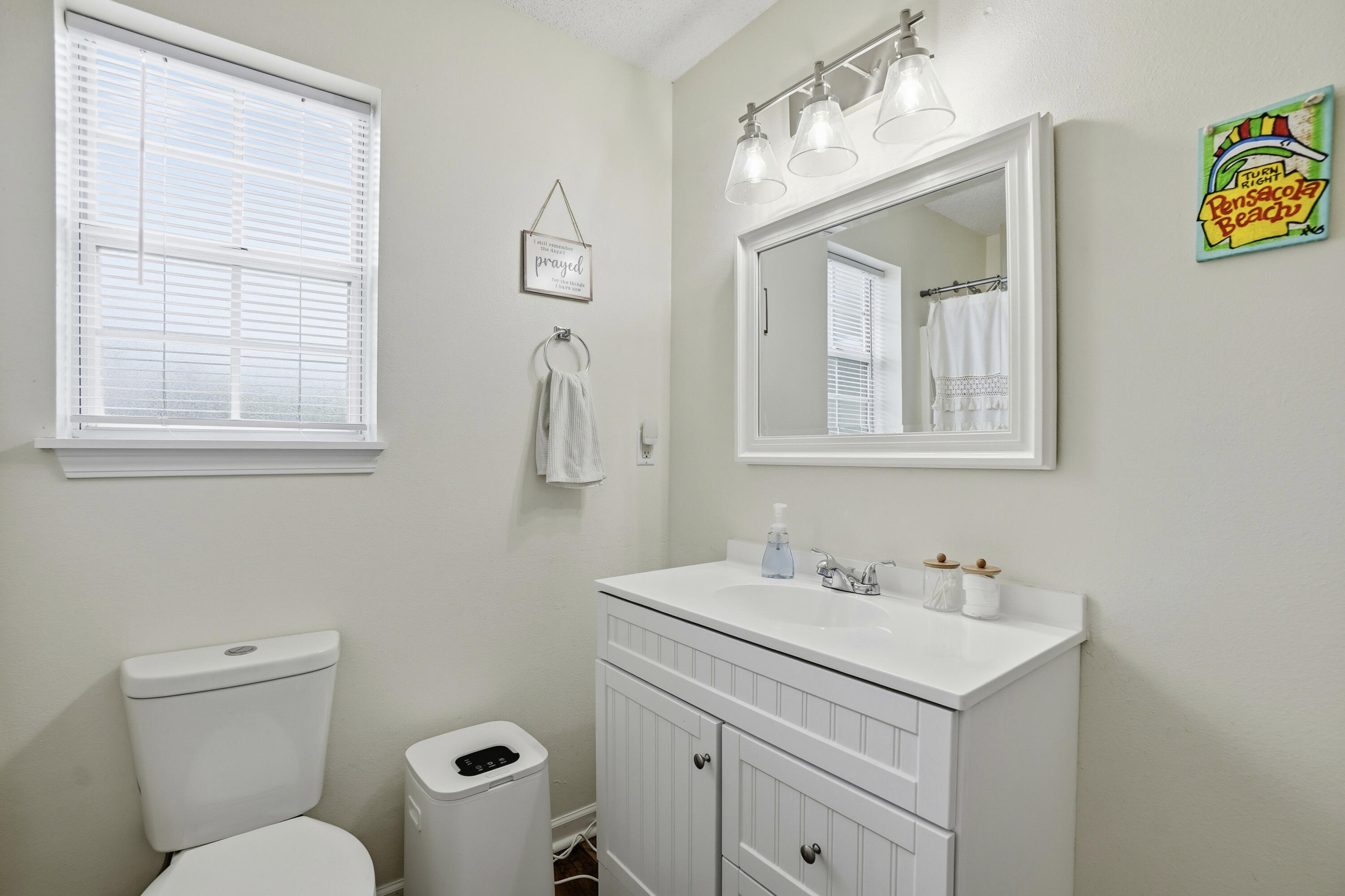 91 Oakridge Way DeFuniak Springs, FL 32433 - Photo 14 of 25 a bathroom with a toilet sink and mirror