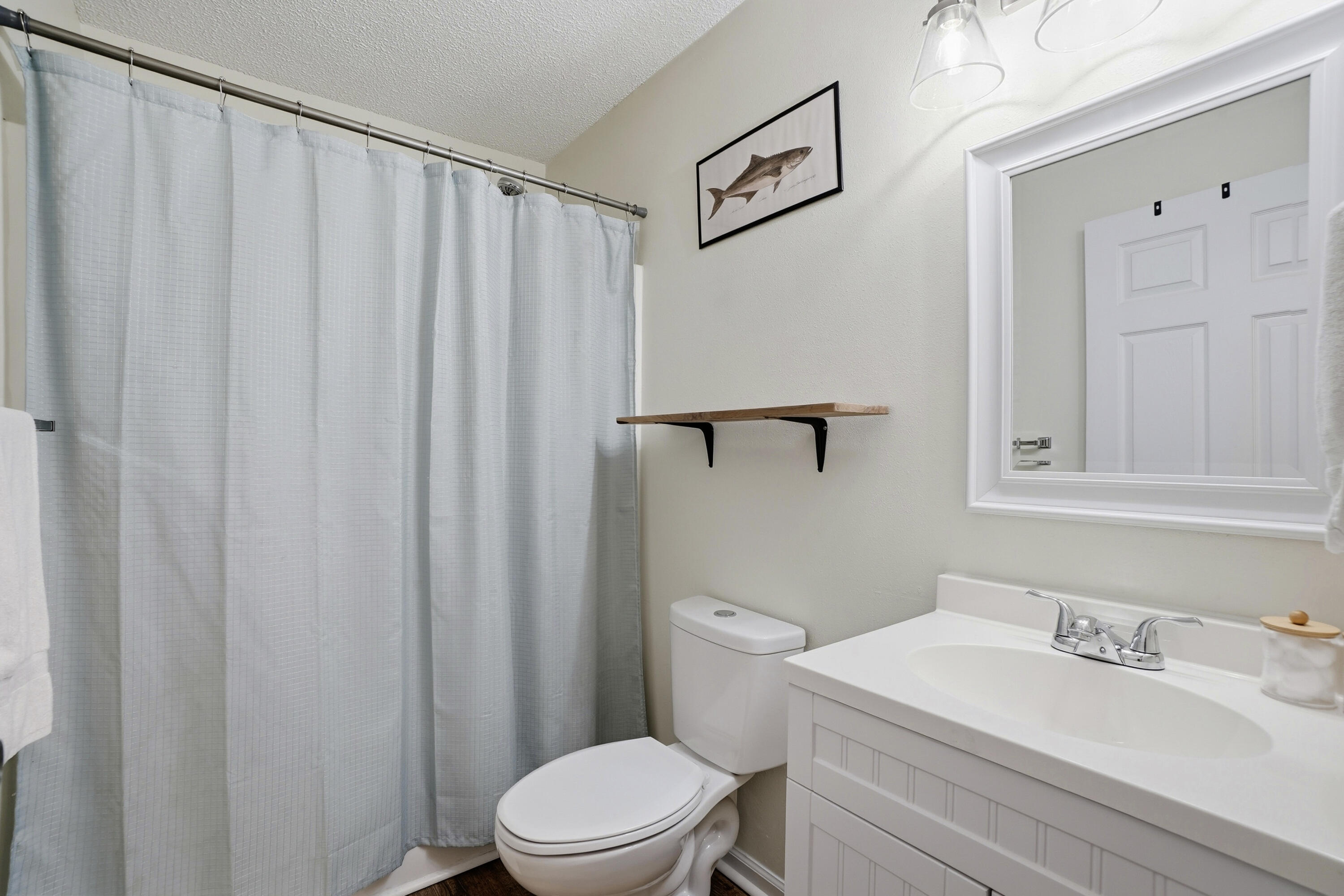 91 Oakridge Way DeFuniak Springs, FL 32433 - Photo 17 of 25 a bathroom with a sink a toilet and shower curtain