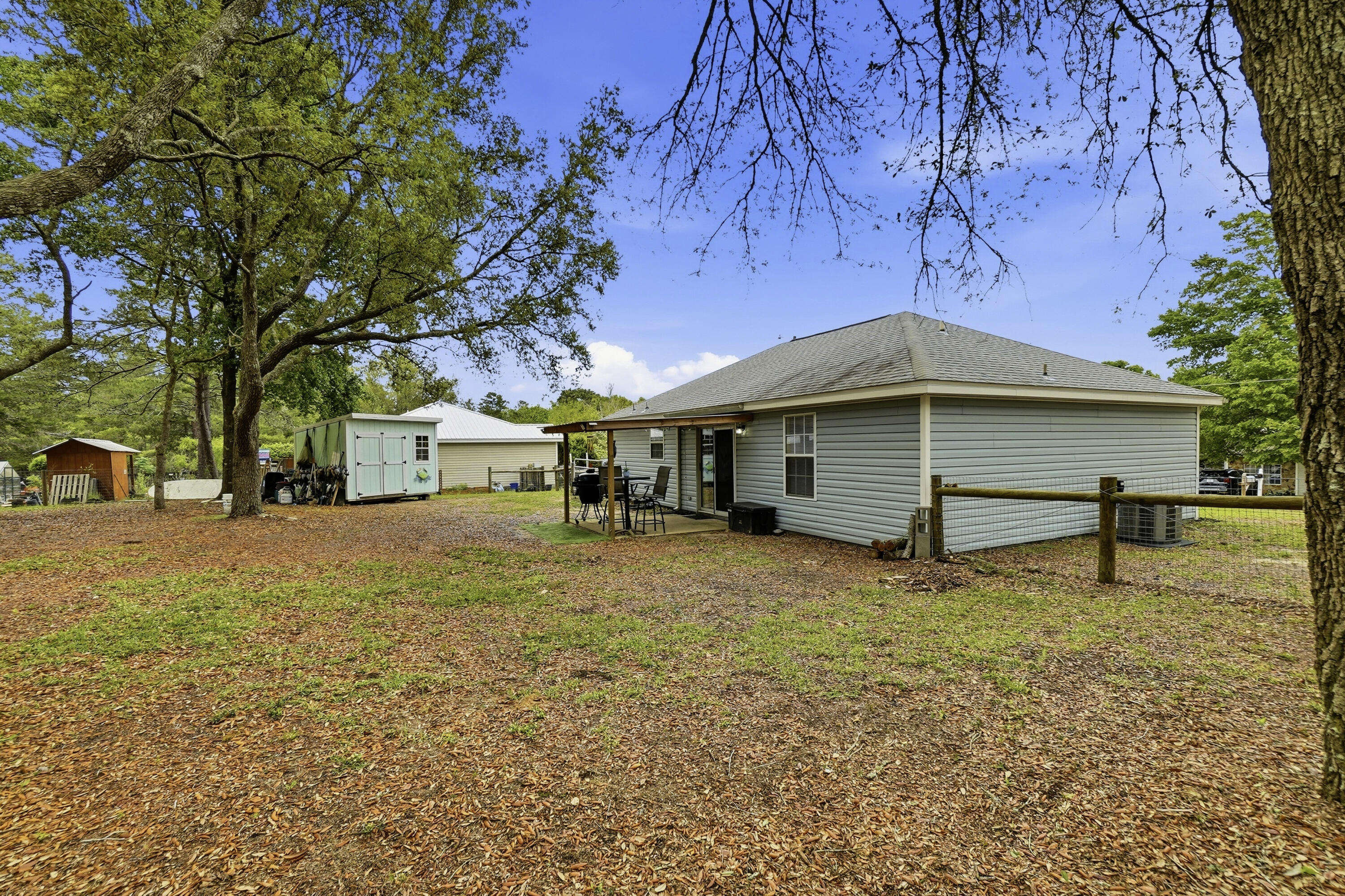 91 Oakridge Way DeFuniak Springs, FL 32433 - Photo 22 of 25 a view of a house with a yard and large tree