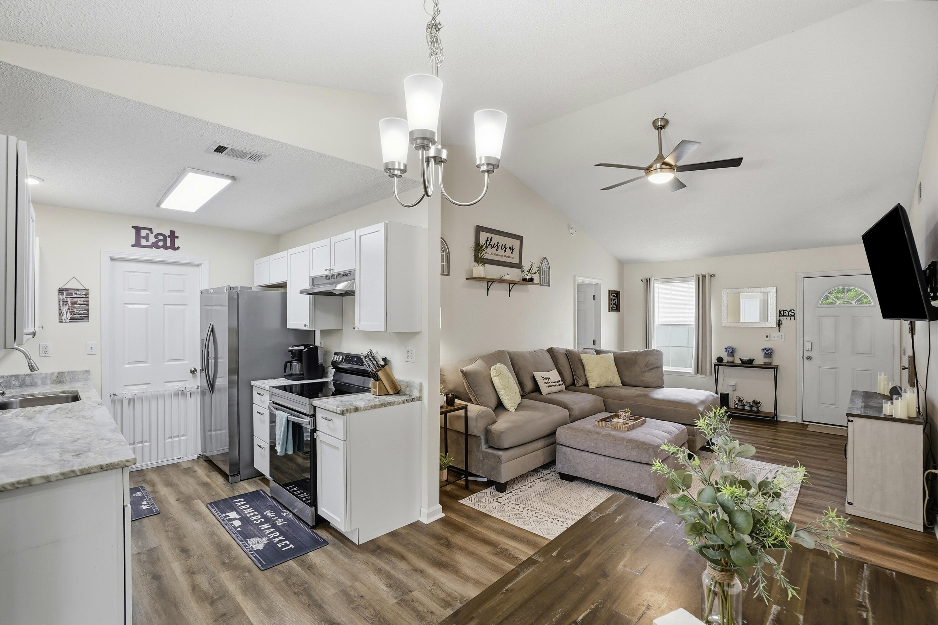 91 Oakridge Way DeFuniak Springs, FL 32433 - Photo 4 of 25 a living room with stainless steel appliances kitchen island furniture and a chandelier