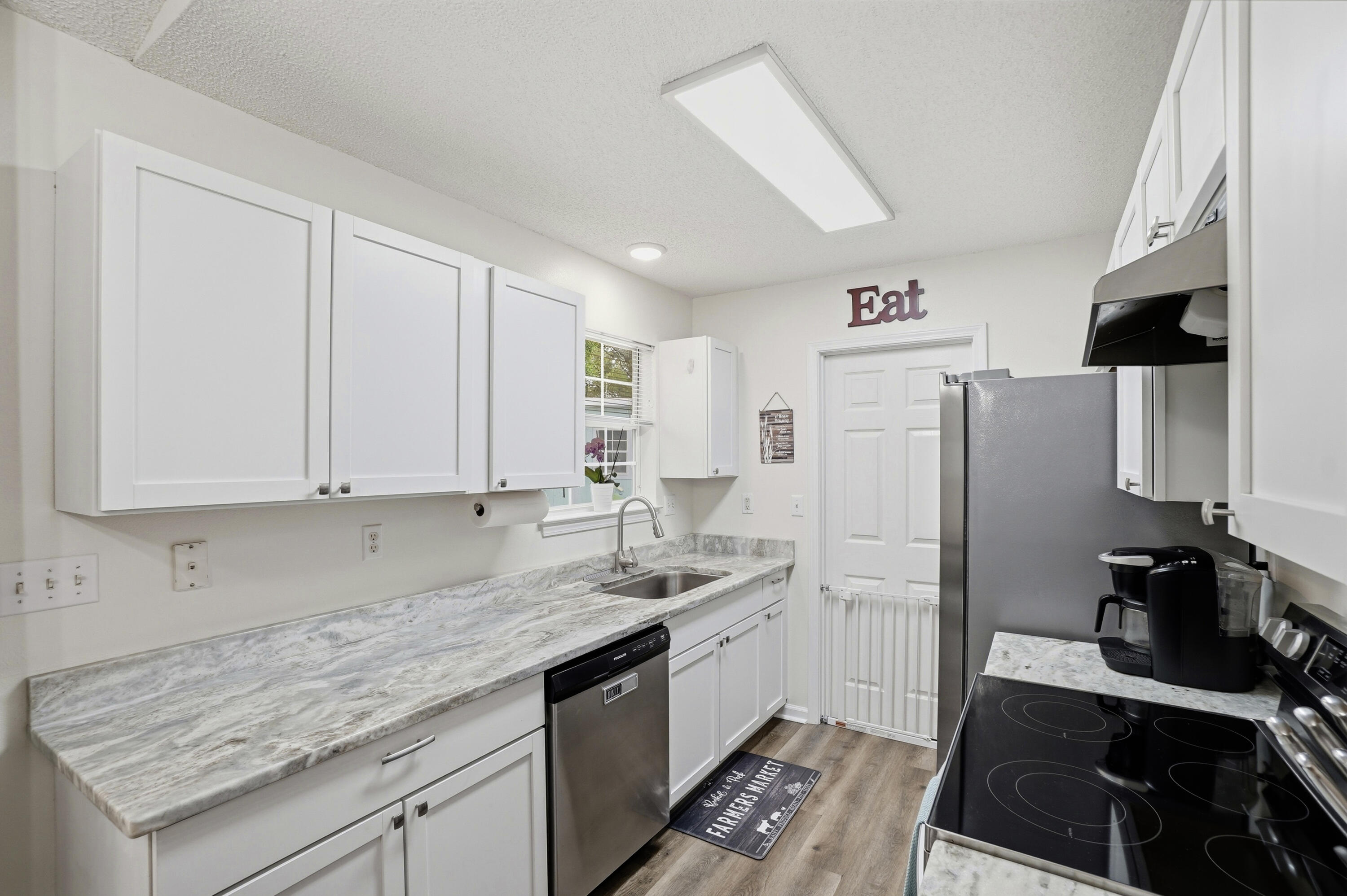 91 Oakridge Way DeFuniak Springs, FL 32433 - Photo 5 of 25 a kitchen with a sink stove and refrigerator