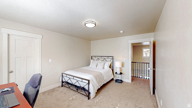 368 East 700 North Springville, UT 84663 - Photo 16 of 55 Bedroom with light colored carpet, a textured ceiling, and a desk