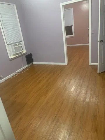 an empty room with wooden floor and door