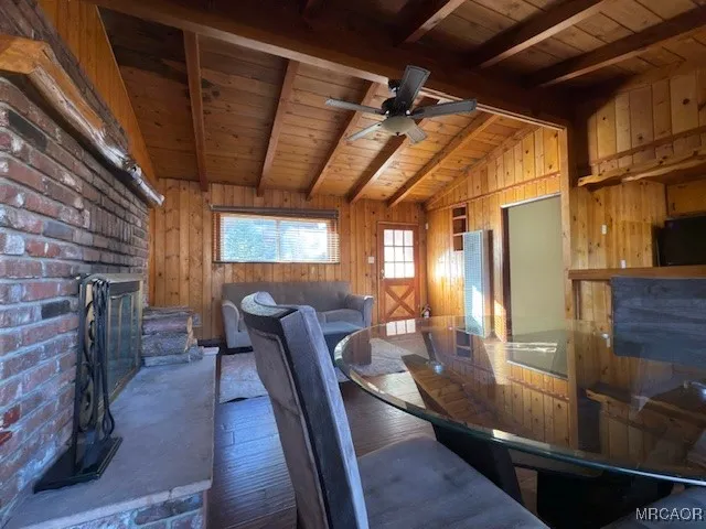 a view of a living room with furniture and a fireplace