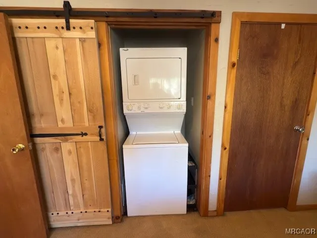 a hallway with wooden floor and closet