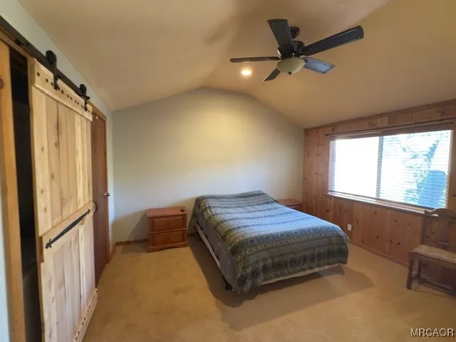 a bedroom with a bed and a television