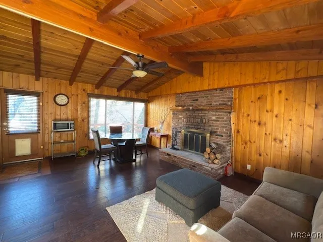 a living room with furniture a fireplace and wooden floor