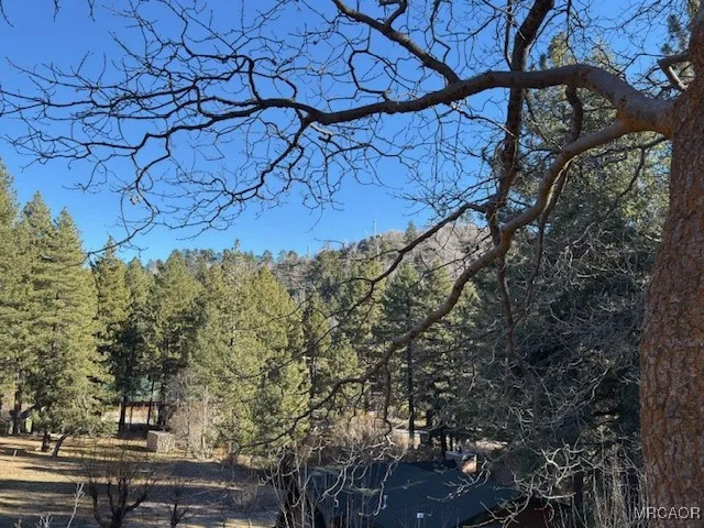 a view of a room with wooden floors and furniture