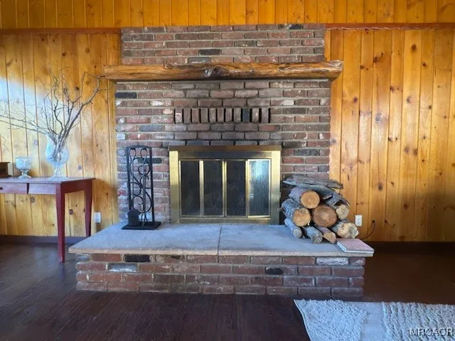 a living room with fireplace furniture and a wooden floor