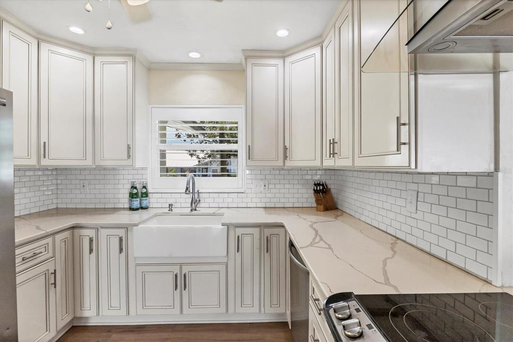 2149 Wason Road Sarasota, FL 34231 - Photo 11 of 32 a kitchen with granite countertop white cabinets and white appliances