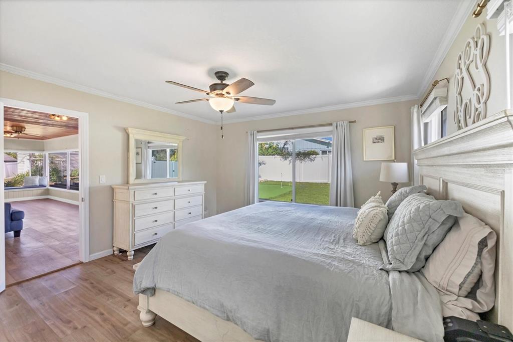 2149 Wason Road Sarasota, FL 34231 - Photo 16 of 32 a bedroom with a bed and a chandelier