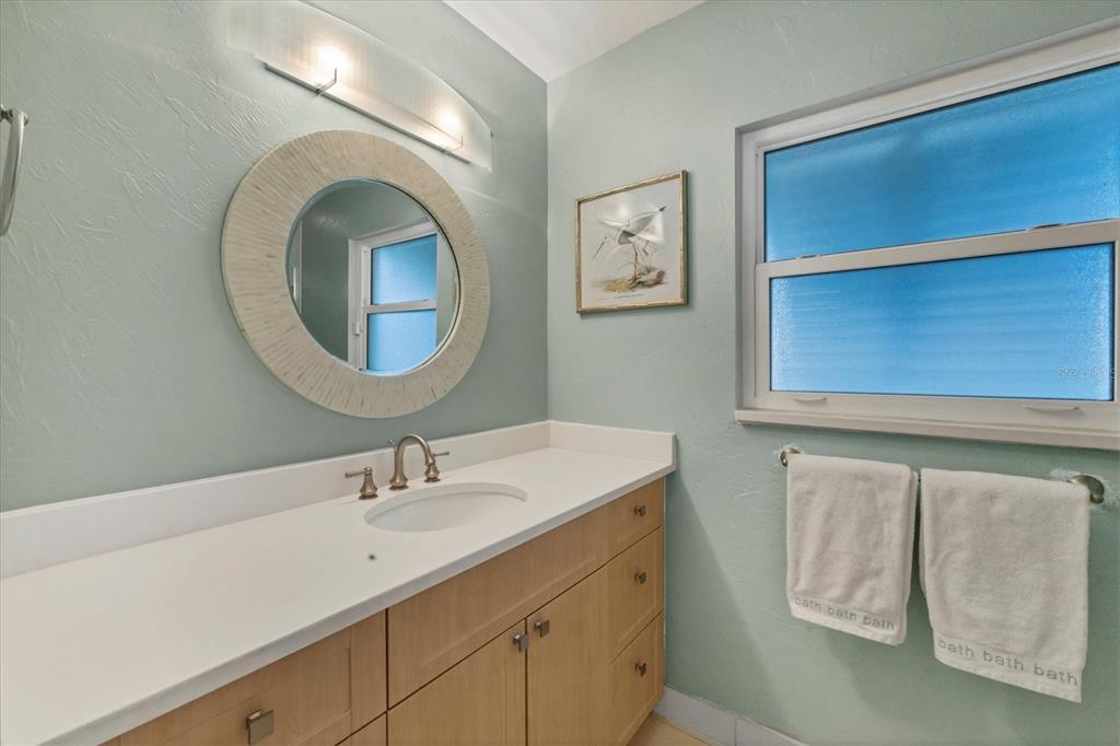 2149 Wason Road Sarasota, FL 34231 - Photo 20 of 32 a bathroom with a sink and a mirror