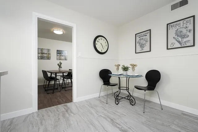 a view of a dining room with furniture and a chandelier
