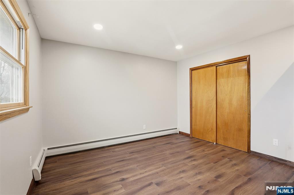 70 Wood Street, Unit 2 Garfield, NJ 07026 - Photo 13 of 23 a view of an empty room with wooden floor and a window