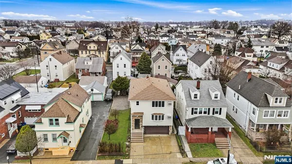 an aerial view of residential houses with city view
