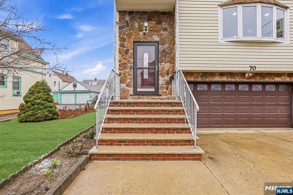 70 Wood Street, Unit 2 Garfield, NJ 07026 - Photo 4 of 23 a front view of a house with a yard