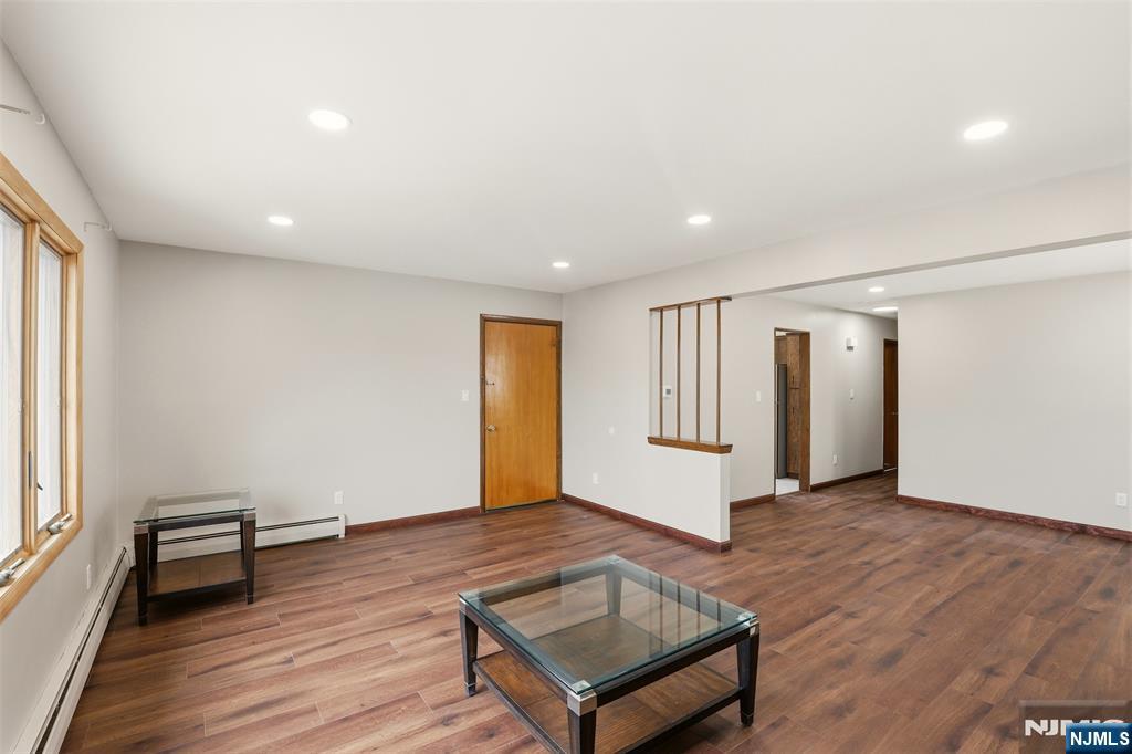 70 Wood Street, Unit 2 Garfield, NJ 07026 - Photo 6 of 23 a view of a big room with wooden floor and windows